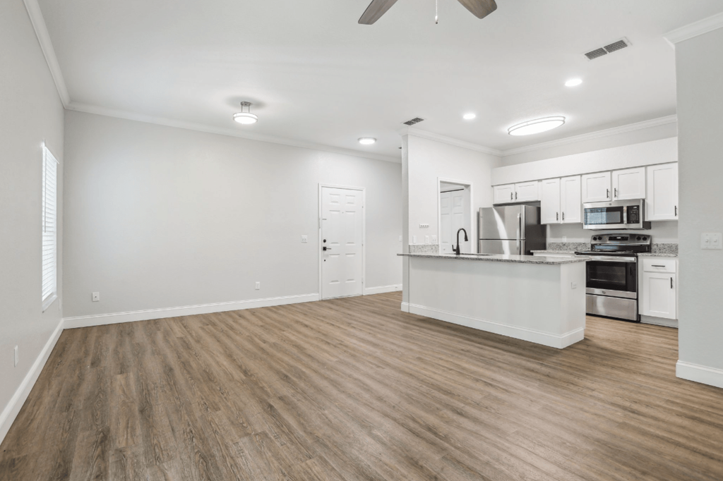 A spacious kitchen with a countertop and stainless steel appliances.